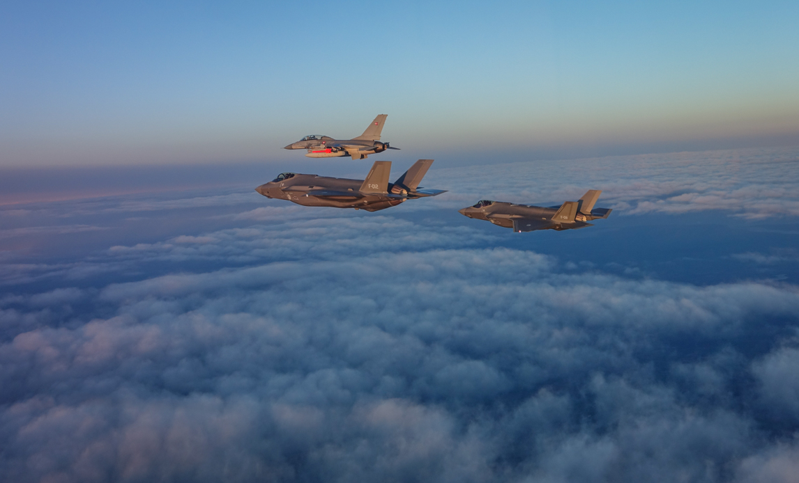 Hollandske F-35’ere flyver sammen med en dansk F-16 over Danmark. Kampflyene deltog i en stor specialoperations flyveøvelse, der løb af stablen i oktober og november. Foto: Flyvevåbnets Fototjeneste.